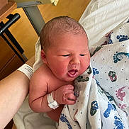 Luka is registered to the contest to win money with this photo: newborn, baby, hospital, blanket, footprint_pattern, wristband, arm, skin, infant, sleepy, cute, person, hospital_bed, healthcare, indoors, closeup, human, newborn_baby, wrapped, expression