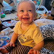 Hunter joined the competition — help win amazing prizes! baby, child, smiling, happy, laughing, portrait, sitting, indoor, toys, stuffed_penguin, playroom, yellow_shirt, striped_pants, blanket, cushion, baby_bottle, infant, face, home, colorful