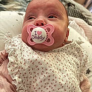 Esmae-Hope joined the competition — help win amazing prizes! baby, pacifier, pink, infant, close_up, face, clothing, pattern, fabric, sleepwear, cute, newborn, soft, indoor, portrait, child, person, resting, young, comfort