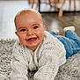 baby, smiling, white_sweater, blue_pants, rug, floor, indoor, happy, cute, child, infant, portrait, hands, eyes, face, crawling, cozy, soft, knitted, home