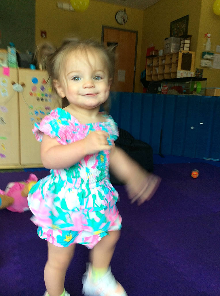 Reese is registered to the contest to win money with this photo: baby_toddler_clothing, blond, child, dress, electric_blue, event, eye, floor, flooring, fun, hair, happy, head, iris, joy, person, picture_frame, room, skin, smile