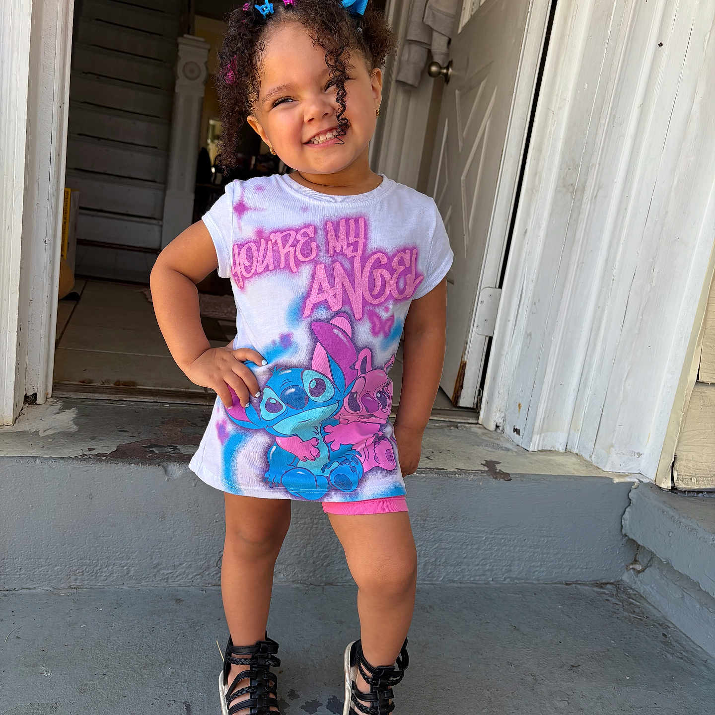 Ya Velise joined the competition — help win amazing prizes! child, clothing, concrete, curly_hair, cute, daylight, door, footwear, hair_clips, happy, outdoor, person, porch, pose, sandals, shirt, smiling, standing, steps, toddler