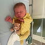 newborn, baby, sleeping, yellow_clothing, plush_toy, hospital_bassinet, infant, blanket, bed, cute, child, portrait, peaceful, soft_toy, hospital, lying_down, indoors, face, small, resting