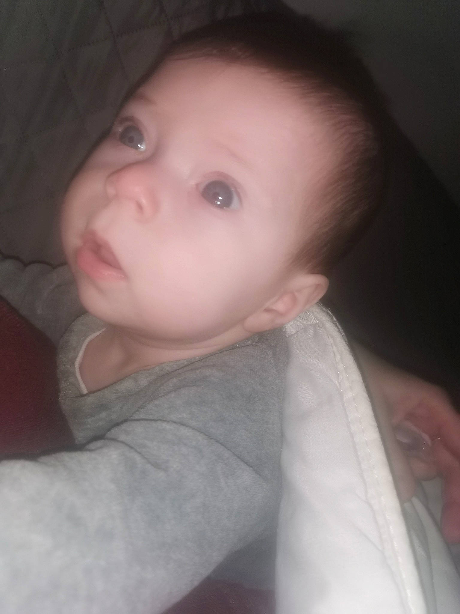 Noéline a rejoint le concours — aidez-le/la à gagner de superbes lots ! baby, black_hair, cheek, chin, comfort, ear, eyebrow, eyelash, flash_photography, forehead, grey, human_body, iris, lip, mouth, nose, person, skin, sleeve, smile