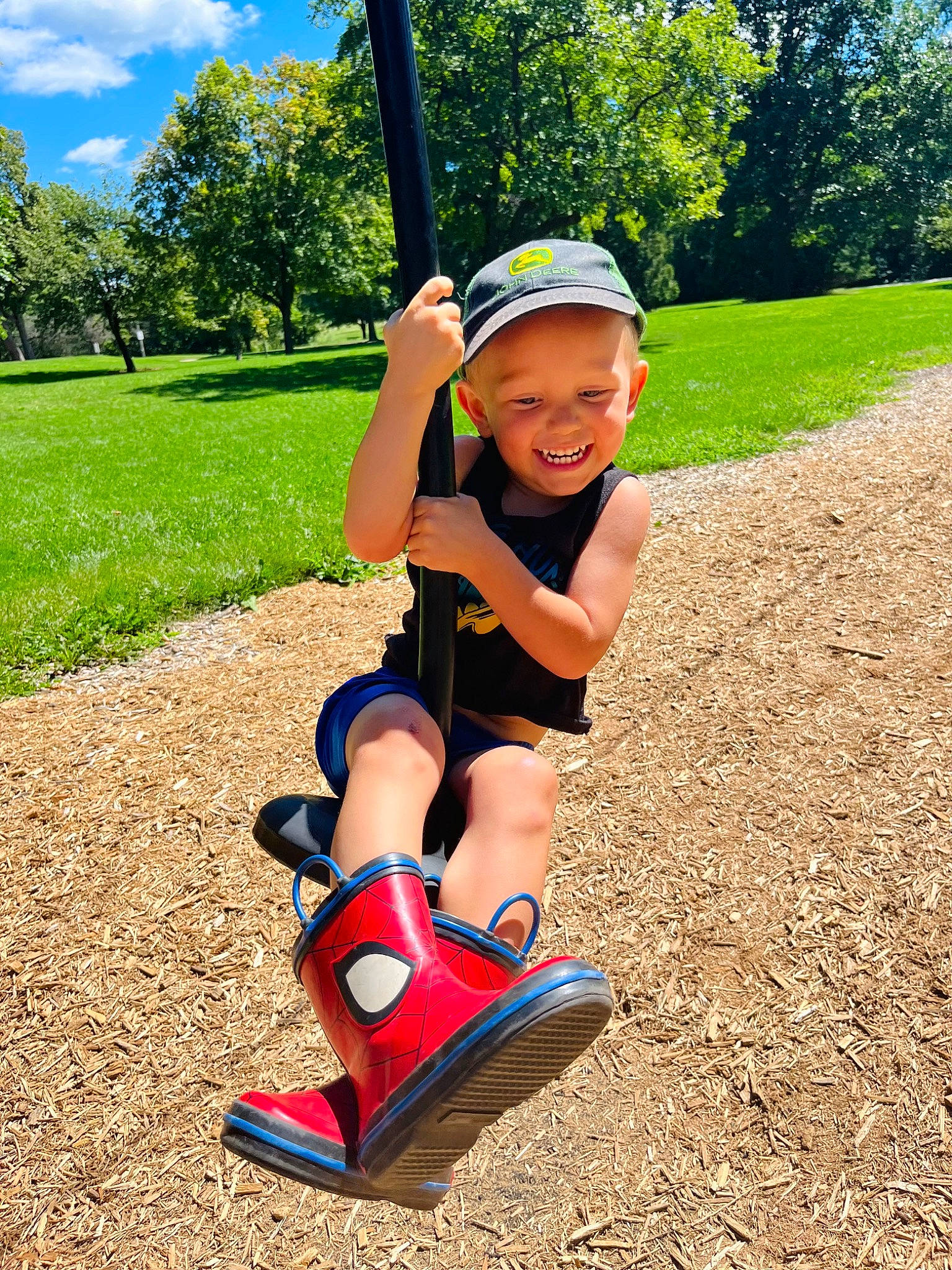 Landen is registered to the contest to win money with this photo: child, cloud, fun, grass, happy, hat, headwear, human_body, human_leg, joy, knee, leisure, outdoor_play_equipment, people_in_nature, person, plant, recreation, sky, smile, summer