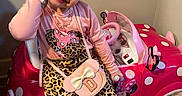 Dayanis is registered to the contest to win money with this photo: accessories, boots, child, cute, education_poster, floor, girl, hair_accessory, happy, indoor, leopard_print, minnie_mouse, pink_clothing, playful, pose, purse, room, smiling, toy_car, wooden_floor