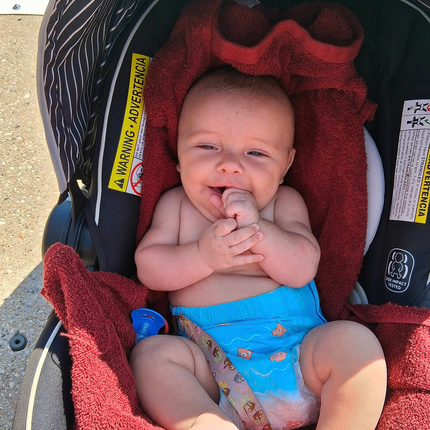 Johnny joined the competition — help win amazing prizes! baby, baby_boy, blue, car_seat, child, closeup, comfort, cute, diaper, happy, infant, outdoor, pacifier, portrait, red, seatbelt, skin, smiling, sunlight, towel
