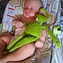 Johnny is registered to the contest to win money with this photo: baby, sleeping, plush_toy, frog, diaper, baby_rocker, blanket, indoor, child, resting, soft_toy, cute, peaceful, infant, comfort, toddler, closeup, person, relaxing, home