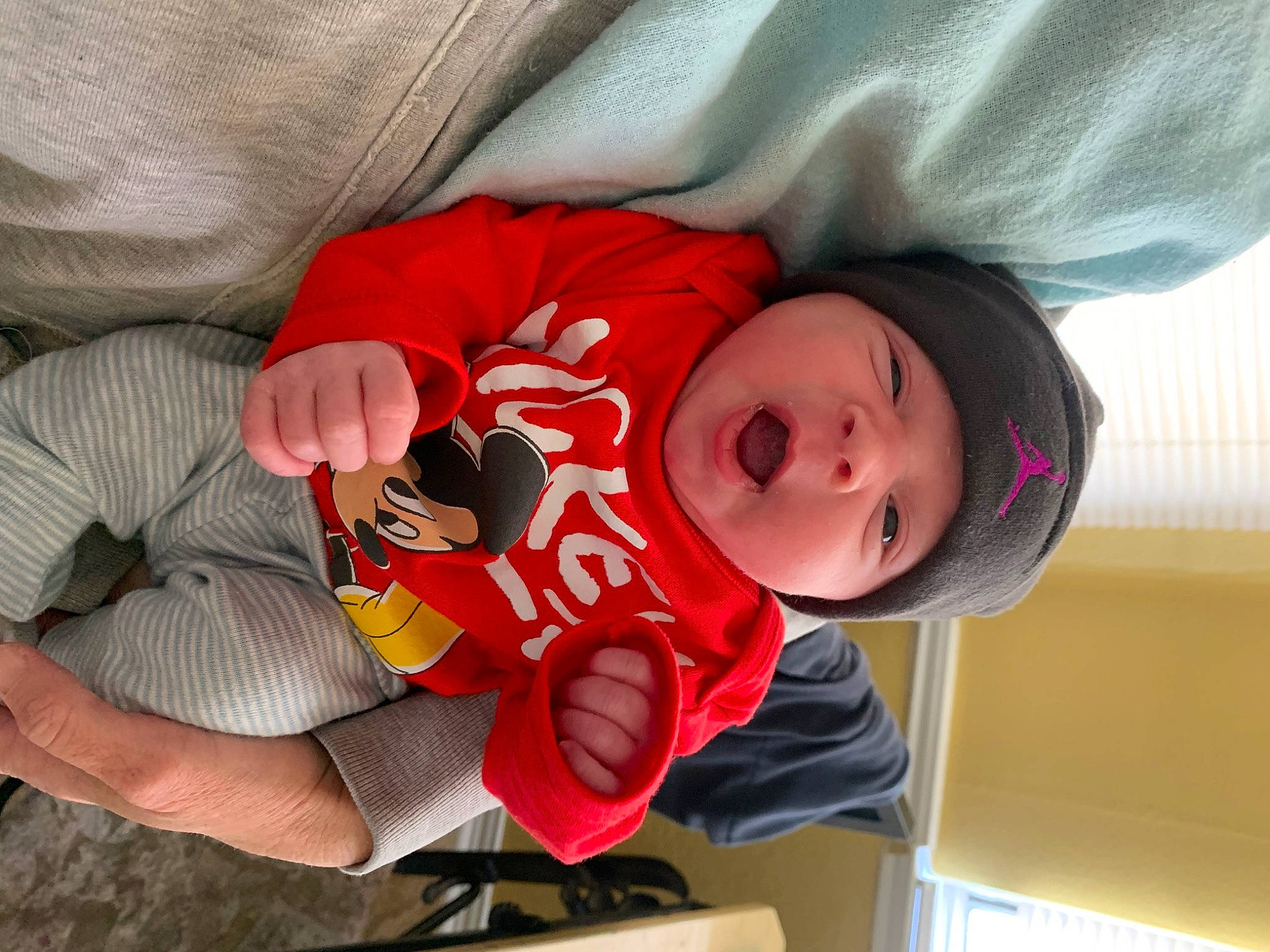 Kyson is registered to the contest to win money with this photo: baby, baby_products, baby_toddler_clothing, carmine, cheek, child, comfort, face, facial_expression, headwear, lap, mouth, nap, person, room, sitting, skin, sleep, sleeve, textile