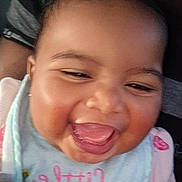 Ahnya-Ann is registered to the contest to win money with this photo: baby, bib, cheeks, child, close_up, clothing, cute, expression, eyes, face, happy, indoors, infant, joy, mouth, person, skin, smiling, tongue_out, young