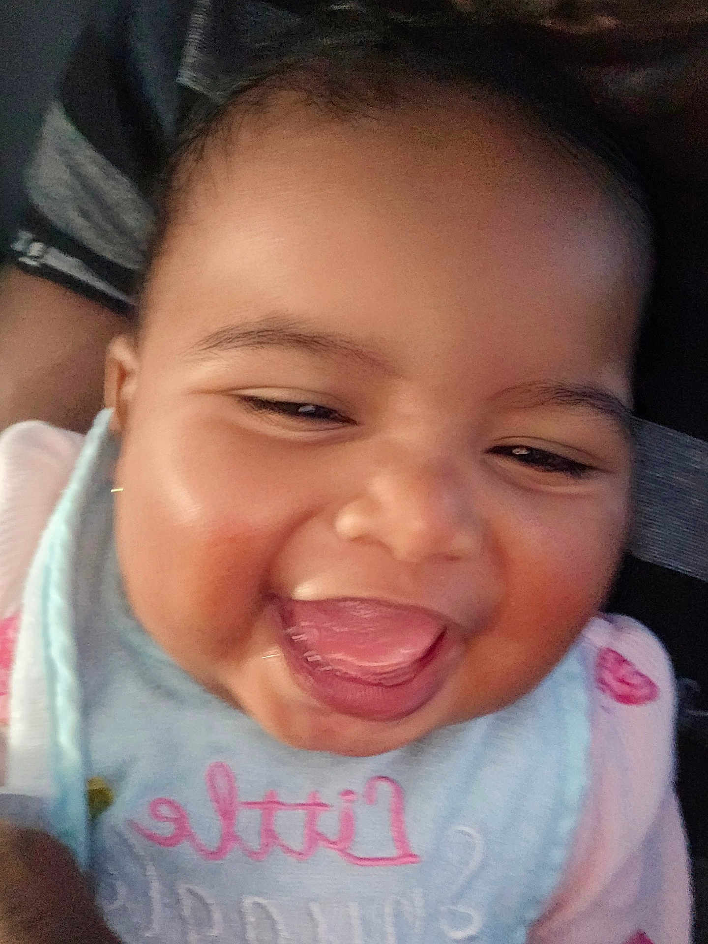 Ahnya-Ann is registered to the contest to win money with this photo: baby, bib, cheeks, child, close_up, clothing, cute, expression, eyes, face, happy, indoors, infant, joy, mouth, person, skin, smiling, tongue_out, young