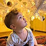 Aurora joined the competition — help win amazing prizes! baby, child, christmas_tree, ornaments, white_tree, glowing_lights, curious, indoors, holiday, decorations, warm_light, crawling, blanket, cute, infant, soft_focus, cozy, toddler, festive, face
