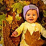 baby, child, autumn, fall_leaves, basket, smiling, purple_hat, yellow_outfit, leaf, outdoor, seasonal, cute, portrait, nature, cozy, happy, infant, playful, warm_colors, baby_face