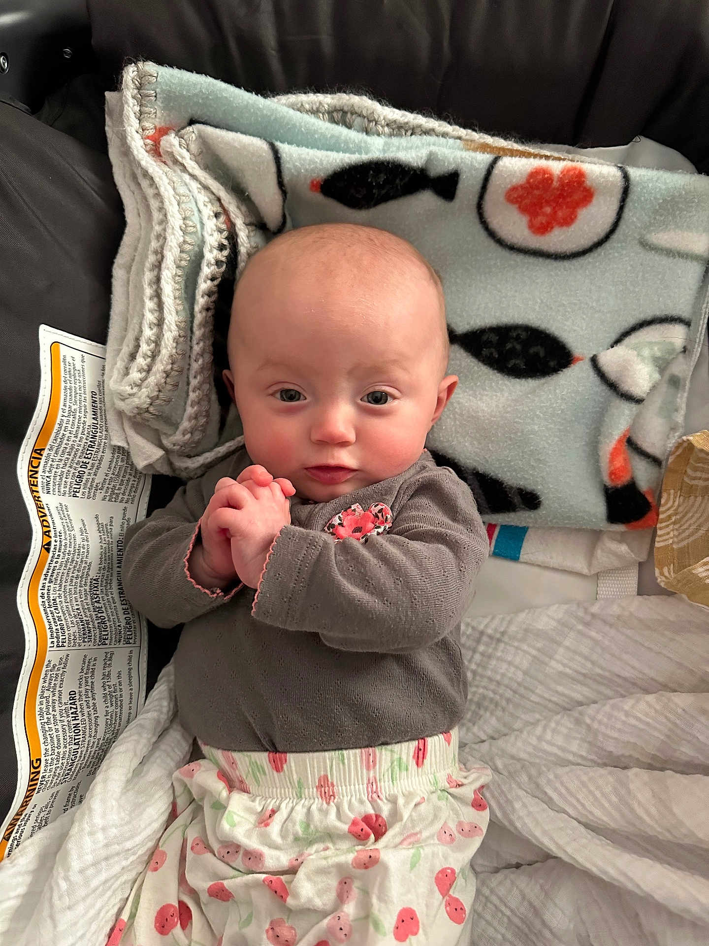 Luna joined the competition — help win amazing prizes! baby, infant, child, blanket, patterned_blanket, knitted_blanket, car_seat, clothing, long_sleeves, pants, hands, face, cheeks, head, eyes, looking_at_camera, cute, indoor, warning_label, fabric