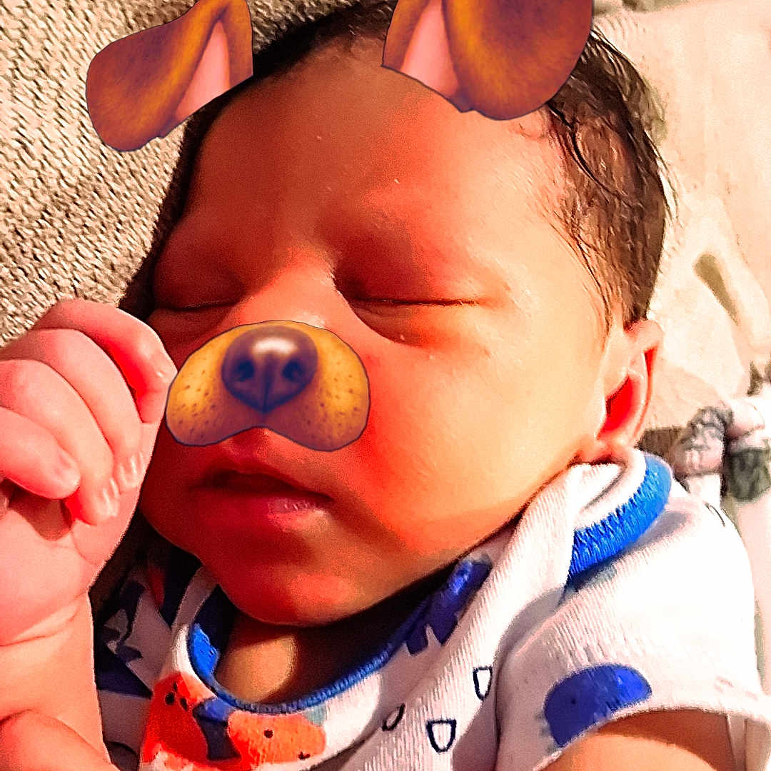 Carmelo joined the competition — help win amazing prizes! baby, sleeping, face_filter, dog_ears, dog_nose, infant, onesie, colorful_clothing, hand, closed_eyes, blanket, cute, indoors, portrait, child, resting, skin, human, young, soft_lighting