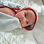 Theodore is registered to the contest to win money with this photo: baby, infant, towel, wrapped, blanket, bed, quilted, face, head, eyes, skin, newborn, cute, lying_down, soft, comfort, indoors, resting, closeup, person