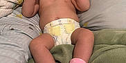 Londyn is registered to the contest to win money with this photo: baby, infant, diaper, socks, bed, blanket, pillow, skin, expression, fist, cute, child, comfortable, indoors, lying_down, soft, sleepwear, newborn, person, toddler