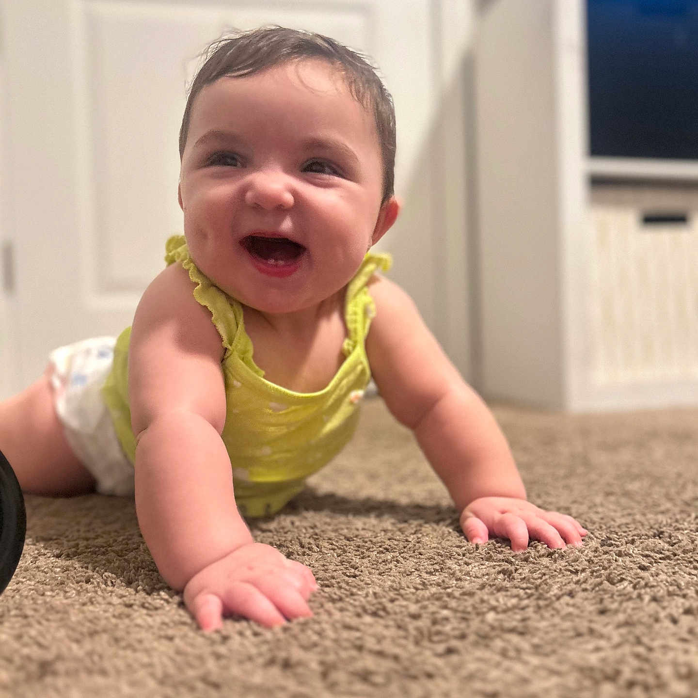 Yasmari is registered to the contest to win money with this photo: baby, carpet, child, crawling, cute, diaper, expression, face, floor, hands, happy, home, indoors, infant, joy, person, room, smiling, yellow_top, young_child