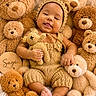 baby, teddy_bear, knitted_clothing, smiling, cute, plush_toys, child, soft_texture, cozy, portrait, infant, cuddly, cute_outfit, handmade, warm_colors, cute_baby, toy, happy, cute_face, baby_boy