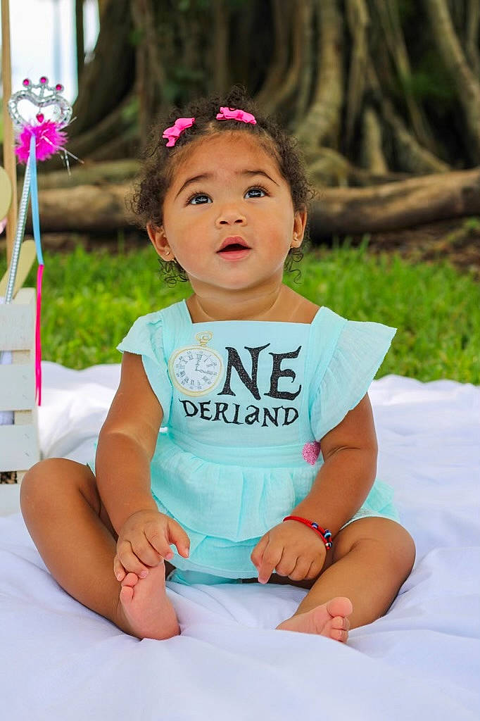 Leilana joined the competition — help win amazing prizes! baby, baby_toddler_clothing, child, dress, event, face, fashion_accessory, flash_photography, fun, grass, happy, headpiece, jewellery, leisure, person, pink, plant, recreation, sitting, skin