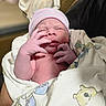 Zaylen is registered to the contest to win money with this photo: newborn, baby, infant, blanket, hat, hand, person, portrait, cute, sleepy, wrapped, soft_lighting, skin, nursery, newborn_hat, newborn_wrapped, baby_hand, baby_face, tender_moment, hospital