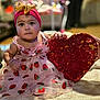 baby, big_eyes, bracelet, carpet, child, closeup, cute, dress, gold_bow, hands, headband, indoors, infant, portrait, red_heart, rosy_cheeks, sequin_heart, sitting, sparkle, strawberry_print