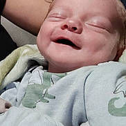 Nikolai joined the competition — help win amazing prizes! baby, smiling, face, infant, clothing, dinosaur_print, sleeping, happy, cute, newborn, person, skin, arm, tattoo, blanket, closeup, portrait, soft, child, cozy