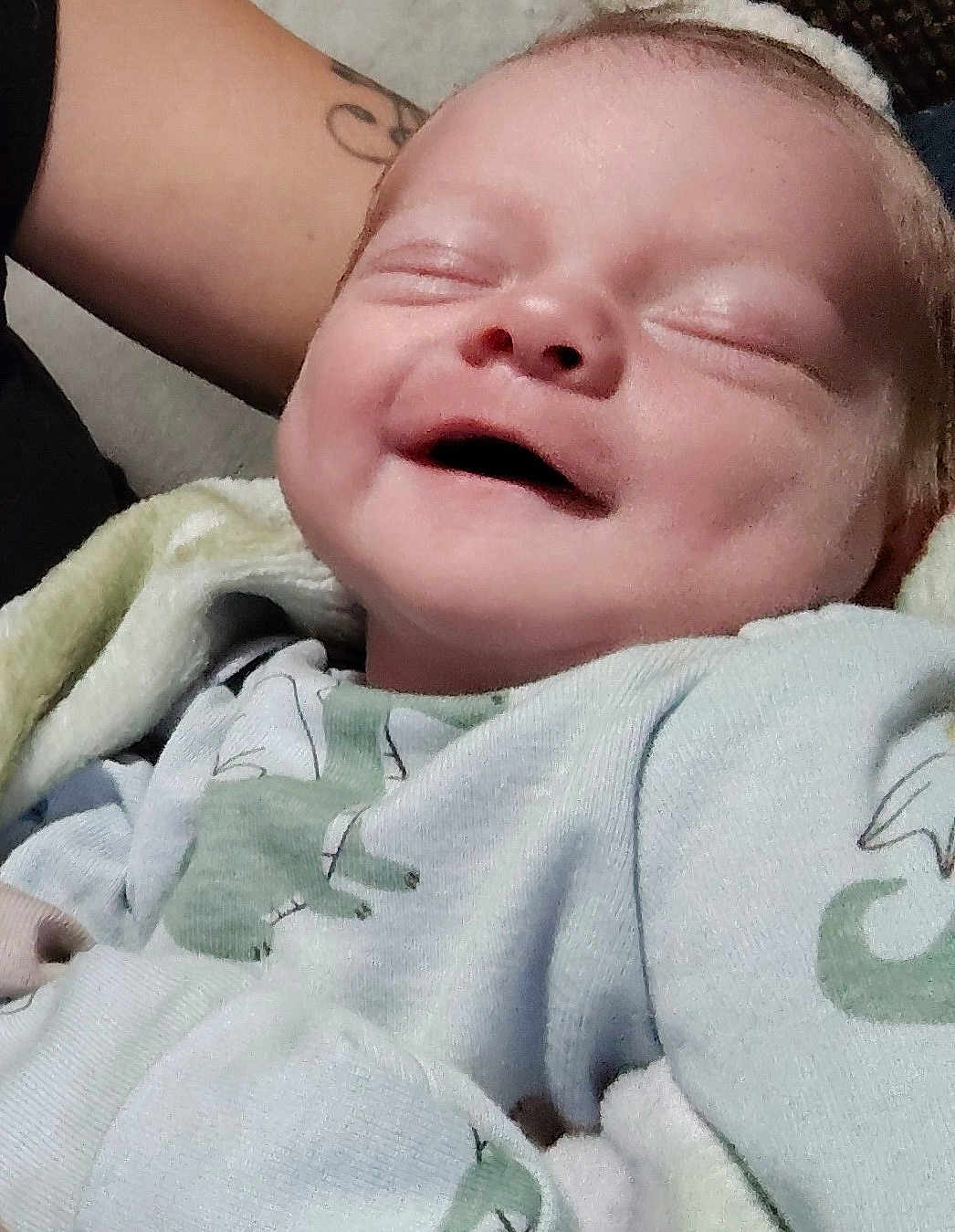 Nikolai joined the competition — help win amazing prizes! baby, smiling, face, infant, clothing, dinosaur_print, sleeping, happy, cute, newborn, person, skin, arm, tattoo, blanket, closeup, portrait, soft, child, cozy