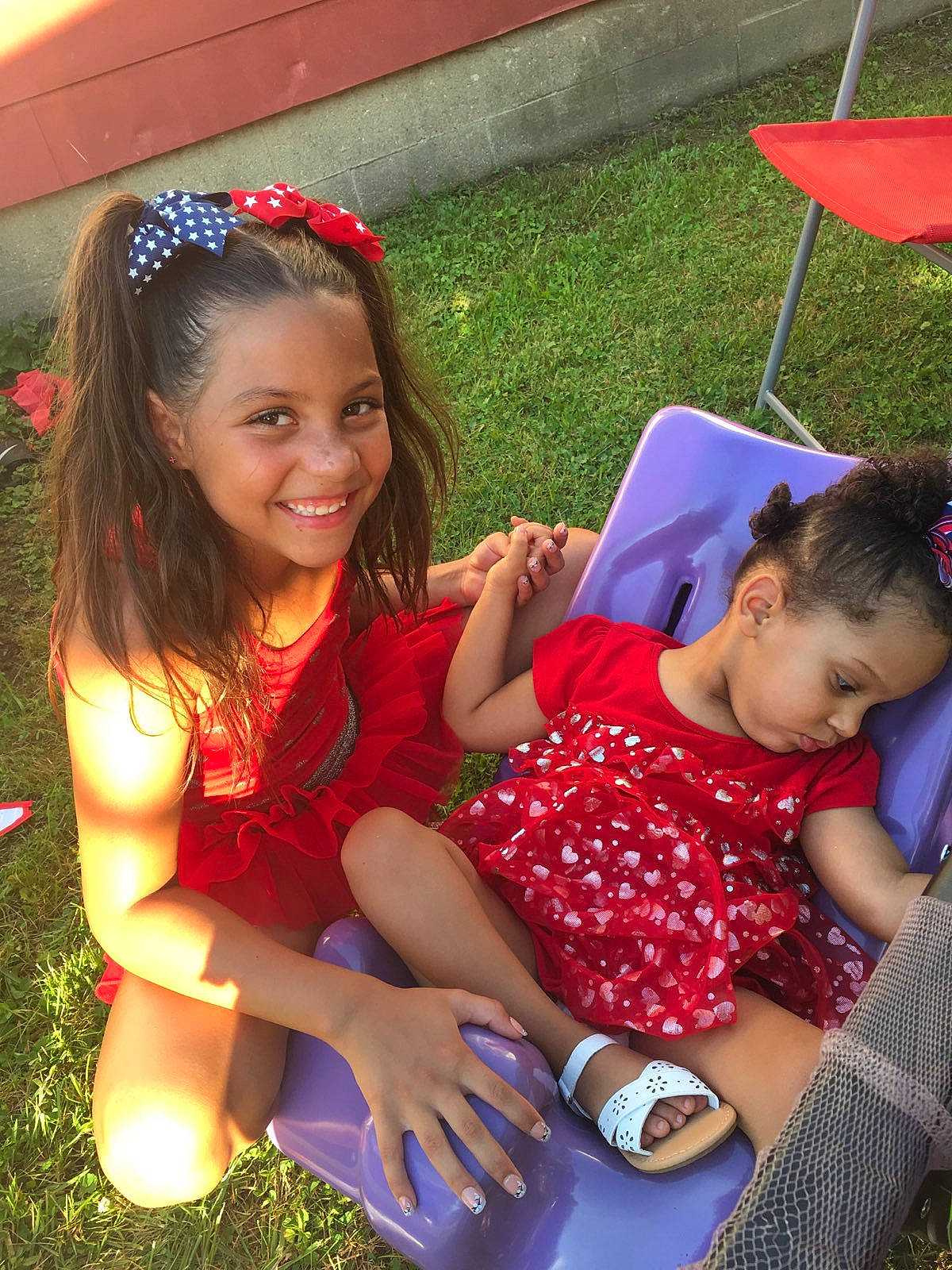 Amya is registered to the contest to win money with this photo: adaptation, child, daughter, fun, grass, happy, joy, leisure, person, play, sibling, sitting, smile, summer