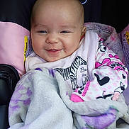October joined the competition — help win amazing prizes! baby, smiling, blanket, car_seat, pajamas, bib, zebra, face, child, infant, happy, cozy, cute, clothing, person, portrait, indoor, closeup, head, soft