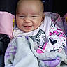 baby, smiling, blanket, car_seat, pajamas, bib, zebra, face, child, infant, happy, cozy, cute, clothing, person, portrait, indoor, closeup, head, soft
