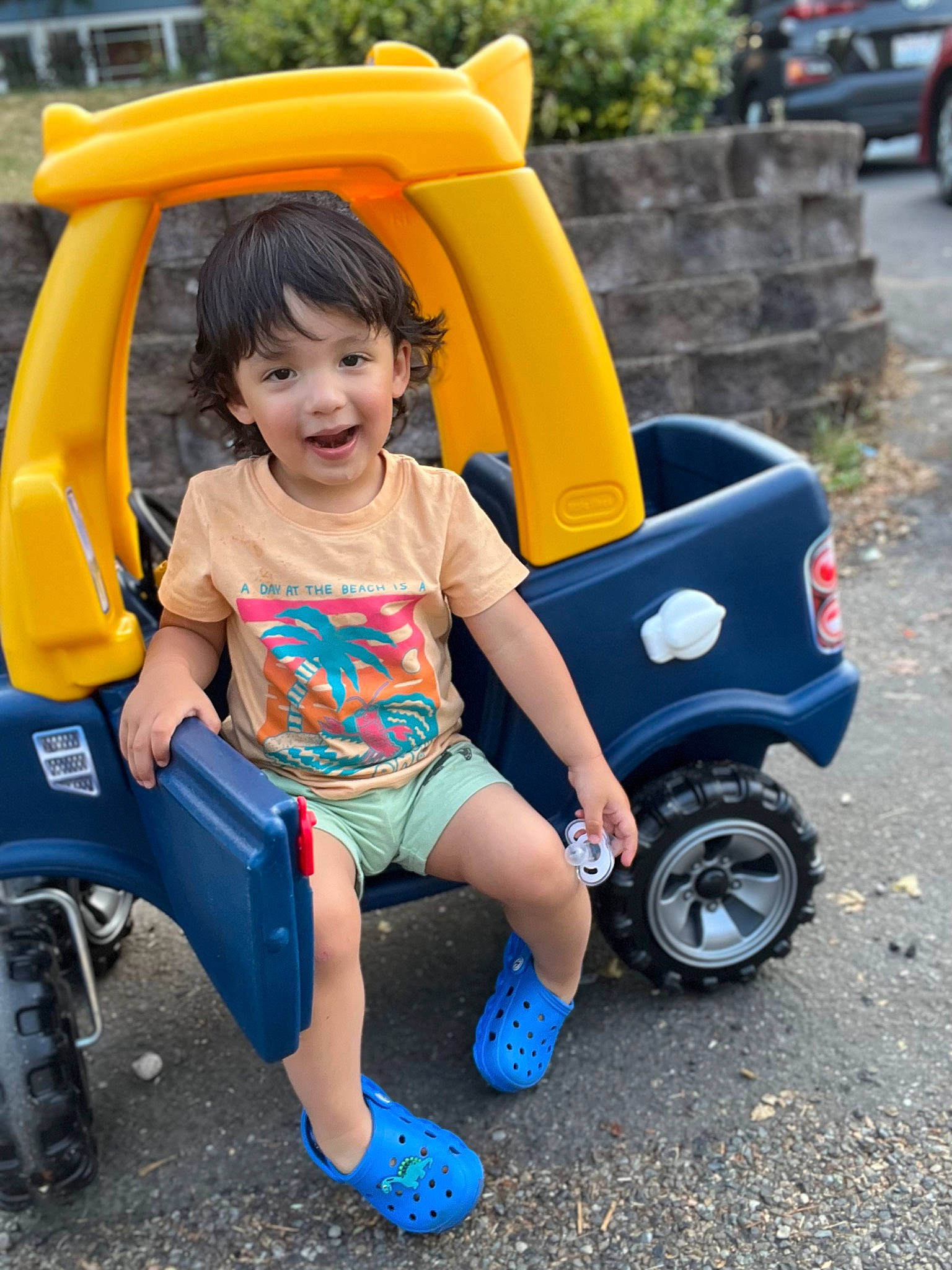 Oliver is registered to the contest to win money with this photo: automotive_design, automotive_exterior, automotive_tire, baby_toddler_clothing, blue, car, electric_blue, fun, happy, leisure, motor_vehicle, person, plant, recreation, smile, tire, toddler, travel, vehicle, wheel