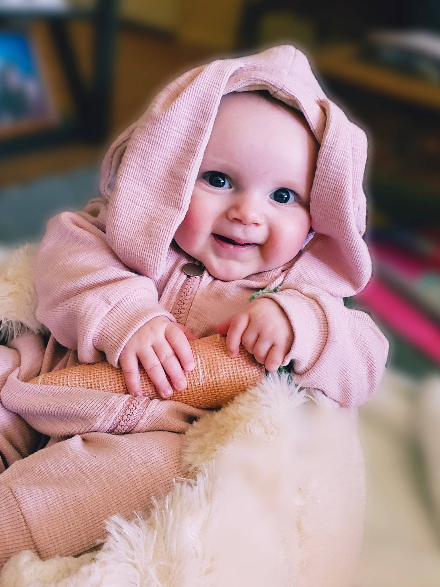 Isabella joined the competition — help win amazing prizes! baby, baby_sleeping, baby_toddler_clothing, child, comfort, face, fur, happy, headpiece, headwear, knit_cap, linens, mammal, peach, person, pink, product, skin, sleeve, smile