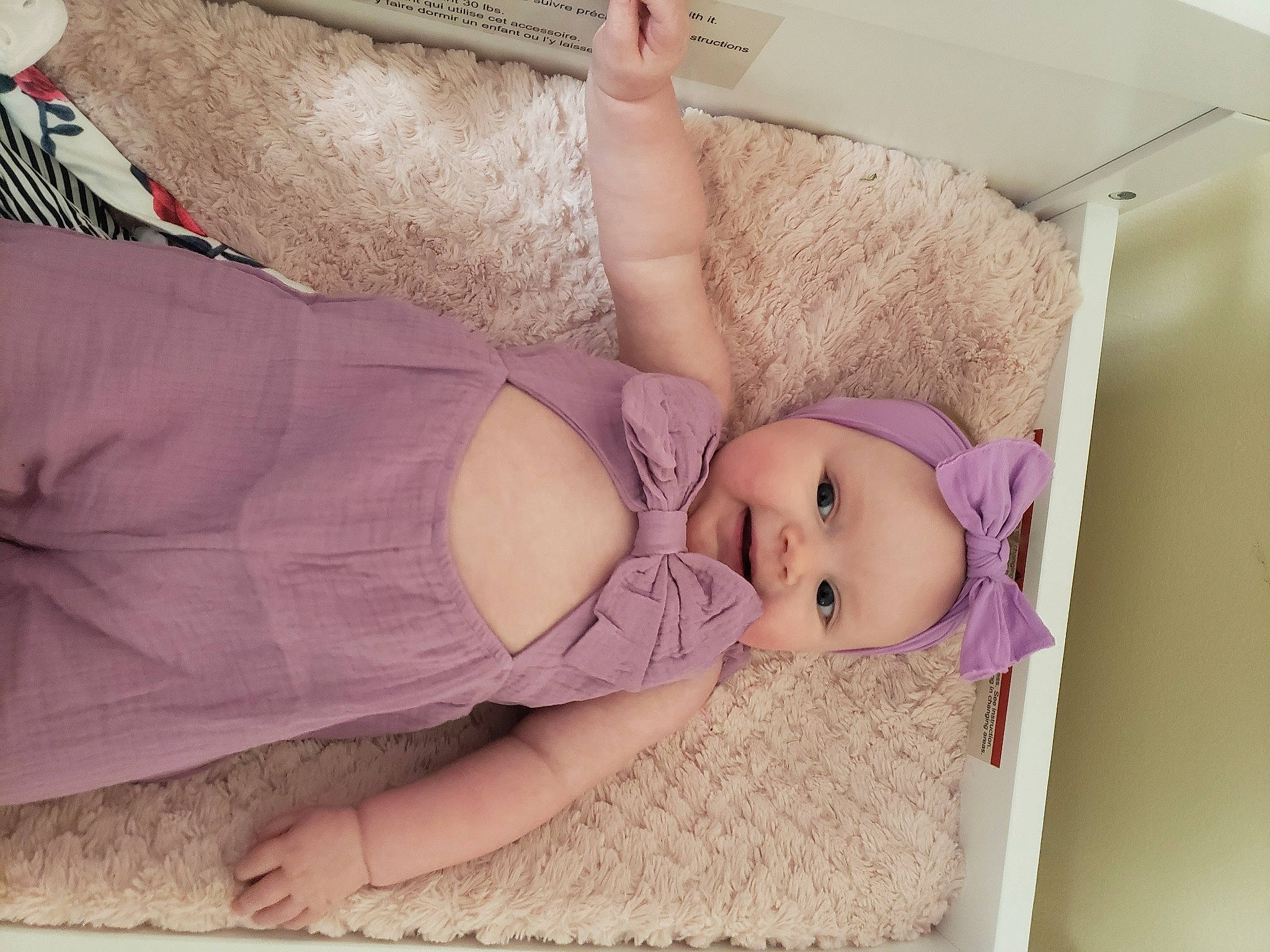 Isabella is registered to the contest to win money with this photo: baby, baby_products, baby_safety, baby_sleeping, baby_toddler_clothing, bedding, child, comfort, headwear, human_body, infant_bed, linens, nap, person, pink, purple, room, skin, textile, thigh