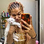 Yuki is registered to the contest to win money with this photo: person, kitten, cat, bathroom, mirror, selfie, braided_hair, bandana, orange_phone_case, toiletries, white_cat, funny_face, holding_pet, indoor, mirror_reflection, shelf, spray_bottle, casual, cute, expression