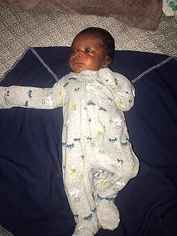 Aydan is registered to the contest to win money with this photo: baby, baby_products, baby_toddler_clothing, bedding, bedtime, cheek, child, comfort, face, fun, head, human_body, linens, nose, person, room, skin, sleep, sleeve, textile