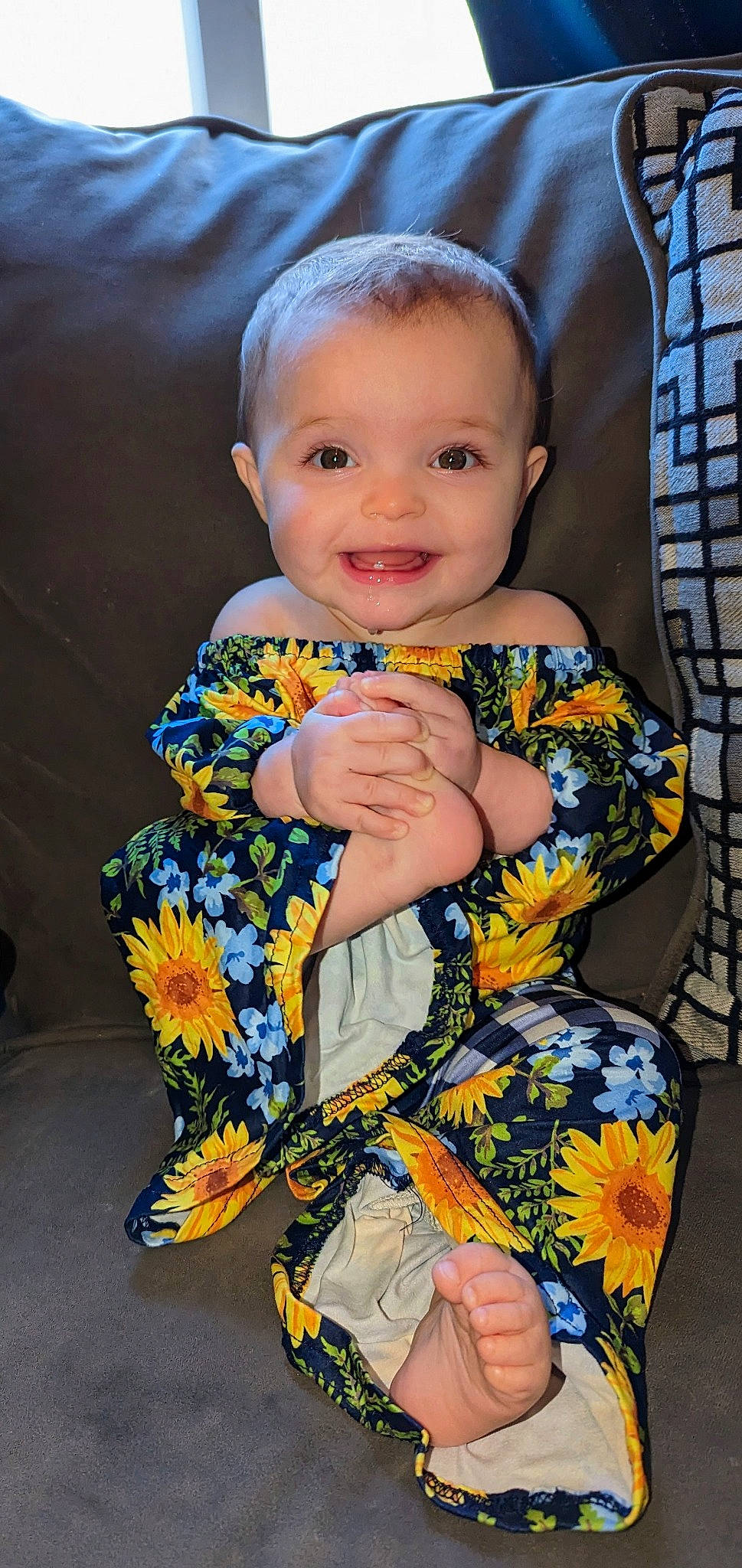 Cheyenne is registered to the contest to win money with this photo: arm, baby, baby_toddler_clothing, cheek, child, dress, electric_blue, eye, facial_expression, hairstyle, hand, happy, iris, joy, pattern, person, skin, sleeve, smile, t_shirt