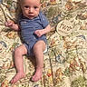 baby, infant, blue_onesie, winnie_the_pooh, blanket, cartoon_characters, lying_down, cute, child, two_months, portrait, looking_at_camera, indoors, soft_lighting, skin, face, hands, feet, expression, young