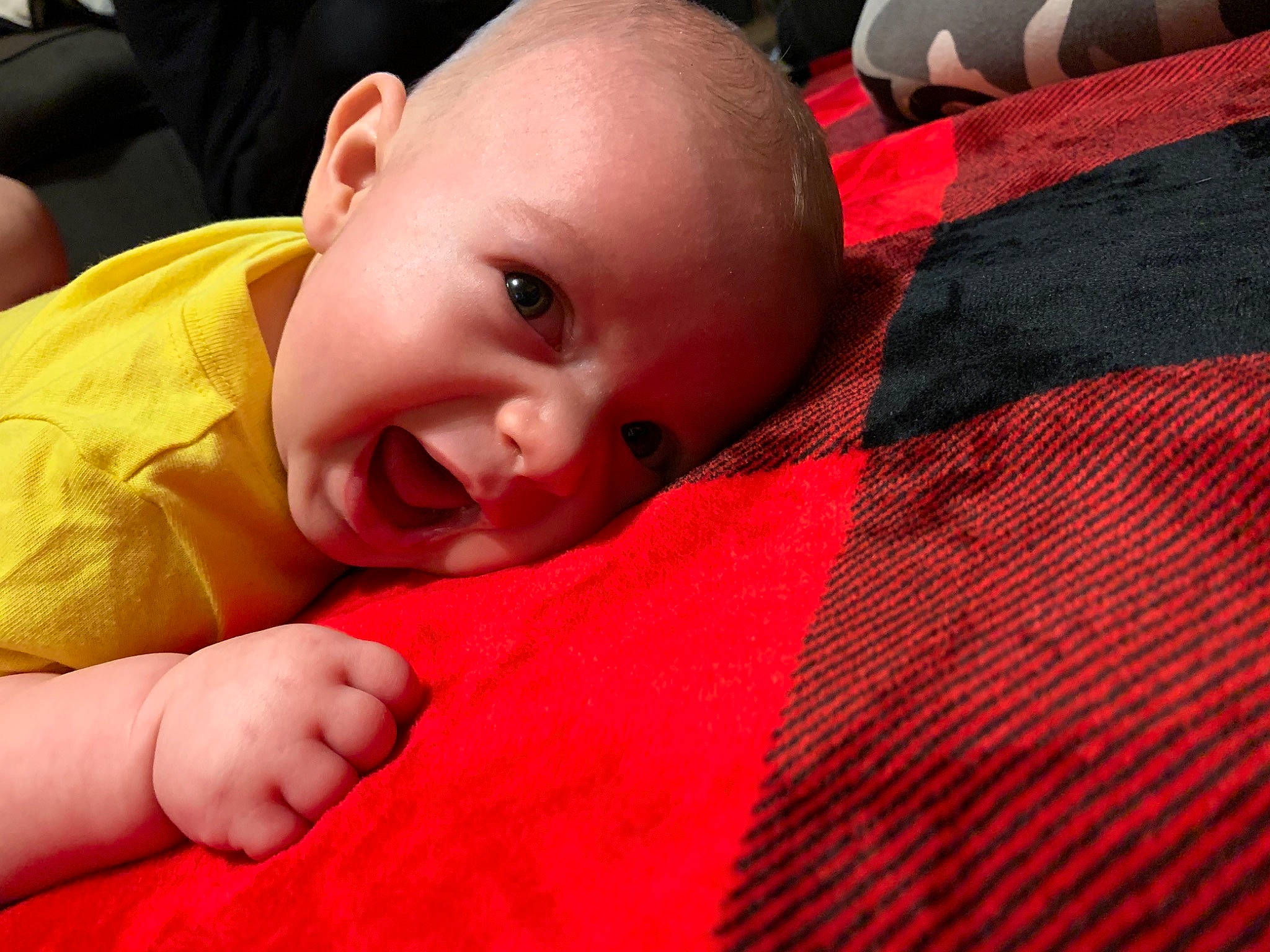 Kodi joined the competition — help win amazing prizes! baby, baby_toddler_clothing, cheek, child, comfort, finger, flooring, gesture, happy, iris, linens, lip, nose, orange, person, plaid, skin, smile, textile, toddler