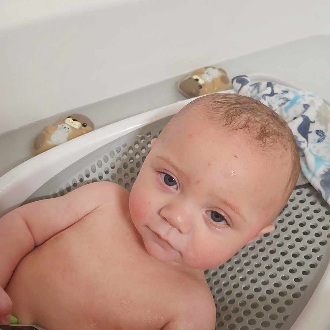 Rylan joined the competition — help win amazing prizes! baby, bath_time, bath_toys, bathroom, bathtub, blue_eyes, child, curious, cute, face, hand, indoors, infant, otter, plastic, remote_control, skin, towel, toy, water
