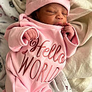 Eliyanah joined the competition — help win amazing prizes! newborn, baby, infant, sleeping, portrait, pink, hat, bow, onesie, clothing, blanket, bed, indoors, face, hands, closed_eyes, peaceful, cute, text_on_clothing, photography