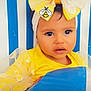 Angel joined the competition — help win amazing prizes! toddler, child, yellow_clothing, bow, headband, bee_motif, butterfly, blue_stripes, striped_background, ball, cute, portrait, face, baby, sitting, bright_colors, adorable, eyes, fashion, playful