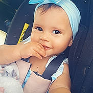 Angel joined the competition — help win amazing prizes! baby, child, car_seat, blue_bow, headband, blanket, smile, face, hand, sitting, seatbelt, clothing, cute, portrait, indoors, infant, person, happy, car, safety