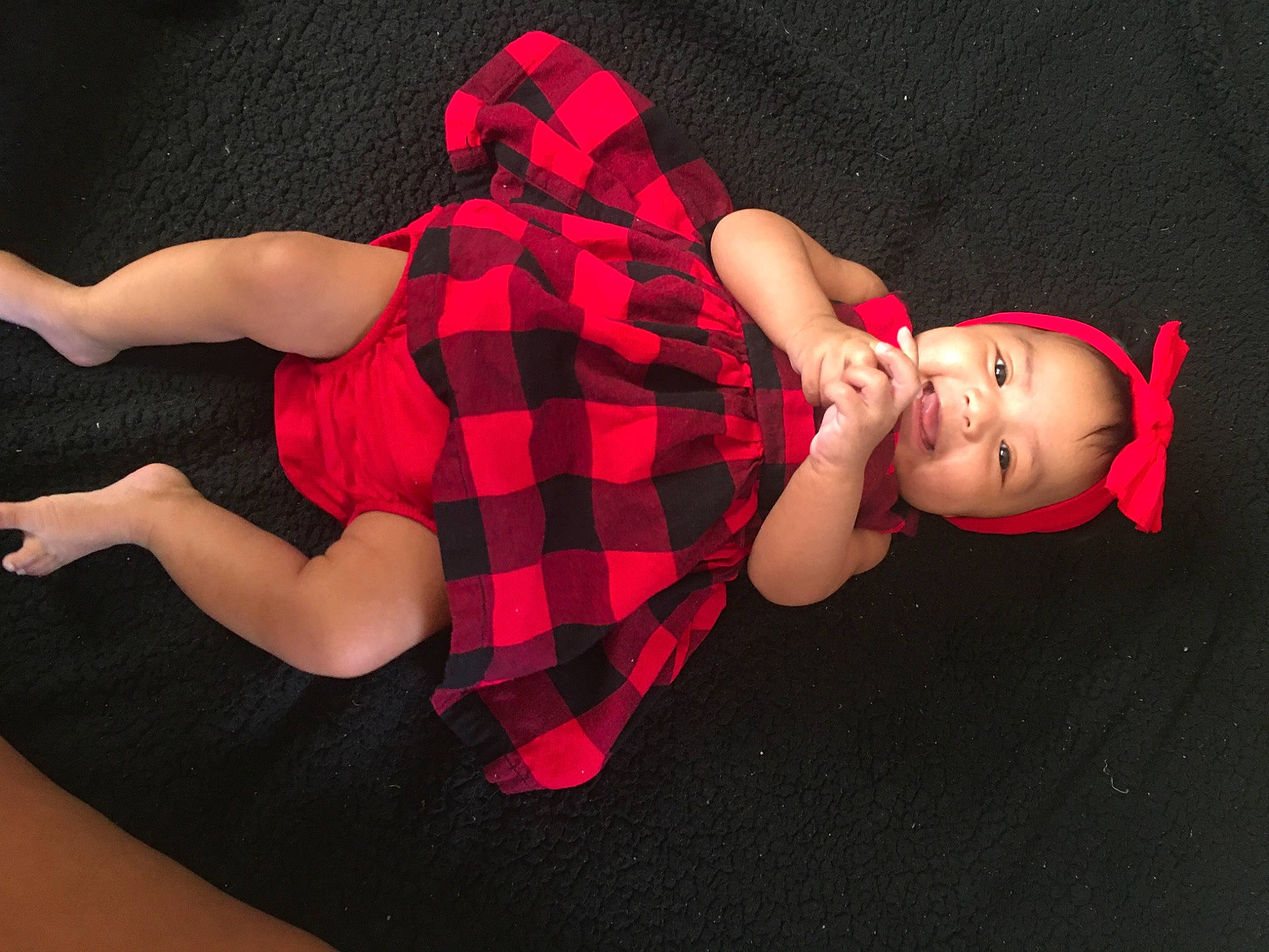 Alani joined the competition — help win amazing prizes! arm, baby, child, design, ear, finger, hand, joint, leg, pattern, person, pink, plaid, red, tartan, textile, toddler