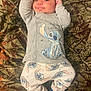 Bryson joined the competition — help win amazing prizes! baby, infant, pajamas, clothing, cartoon_character, stitch, lying_down, blanket, camouflage, pattern, cute, smile, arms_up, blue, white, soft_fabric, sleepwear, person, child, indoors