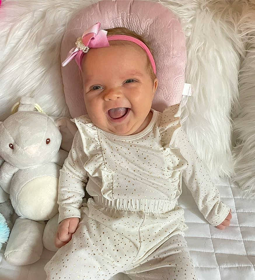 Astrid joined the competition — help win amazing prizes! baby, baby_toddler_clothing, cheek, child, chin, eye, face, happy, head, headband, headgear, headpiece, human_body, iris, person, pink, skin, sleeve, smile, textile