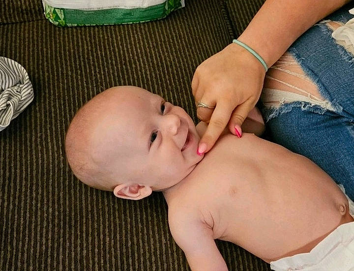 Josiah is registered to the contest to win money with this photo: baby, baby_toddler_clothing, cheek, chest, comfort, eye, face, finger, gesture, hair, happy, head, human_body, mouth, nose, person, skin, smile, stomach, thumb