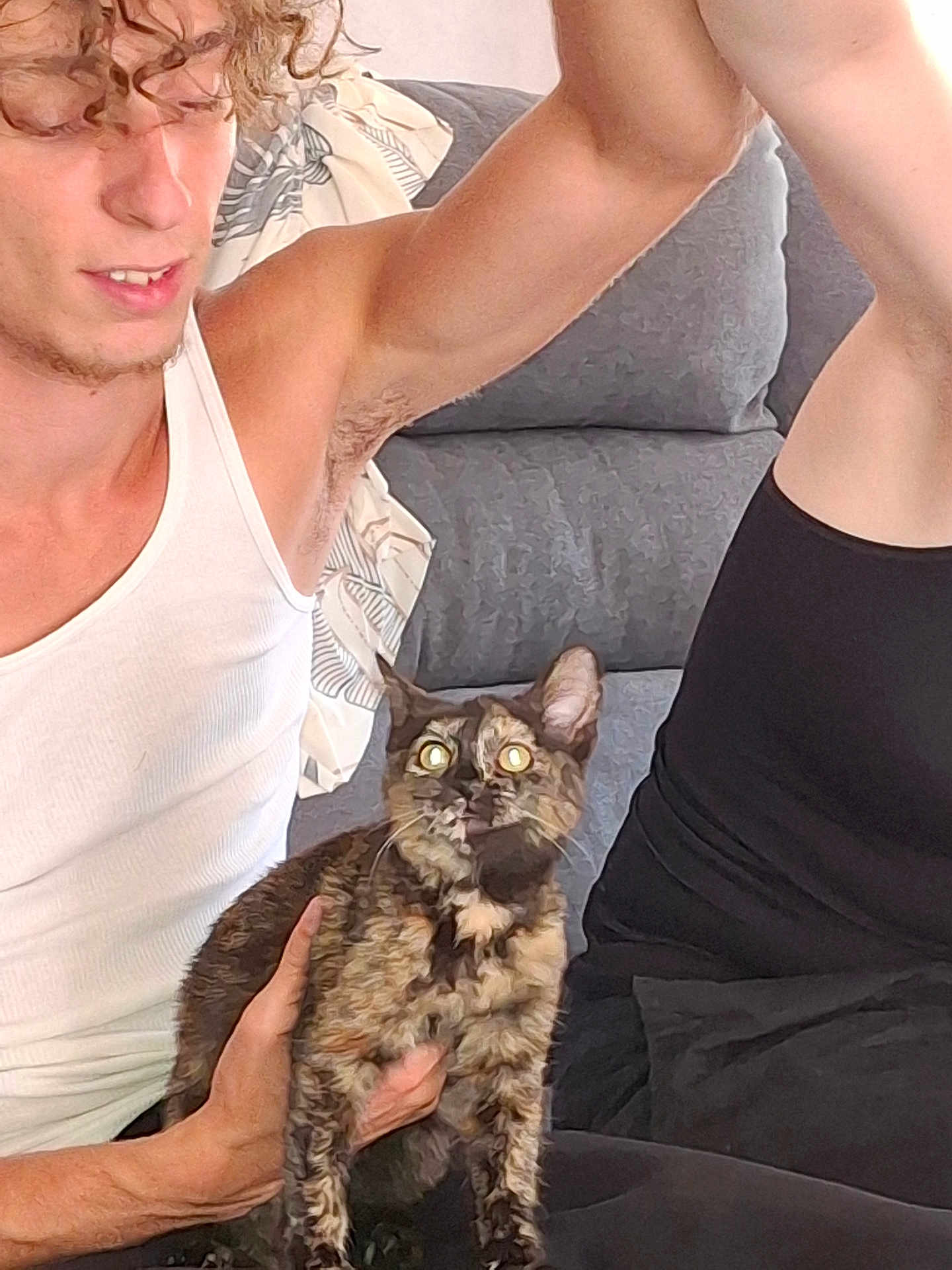 Galaxy participe au concours pour gagner de l'argent avec cette photo : person, cat, tortoiseshell_cat, couch, pillow, white_tank_top, curly_hair, arm, indoor, furniture, pet, holding, seated, cozy, curious, expression, closeup, casual, relaxed, home