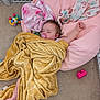 Ivy is registered to the contest to win money with this photo: baby, blanket, pacifier, sleeping, pink_cushion, toy, carpet, baby_gate, foot, hand, infant, soft_texture, colorful_toys, indoor, child, resting, cozy, comfort, play_area, relaxation
