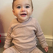 Arabella joined the competition — help win amazing prizes! baby, child, smiling, sitting, carpet, clothing, socks, indoor, face, person, long_sleeve, pants, cute, young, happy, infant, wall, floor, portrait, casual
